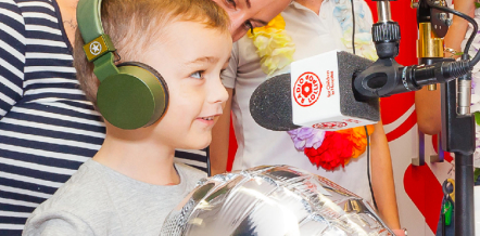 Young boy on microphone at Radio Lollipop