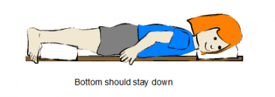 Prone lying face down with a pillow supporting the front of legs, keeping the bottom down.